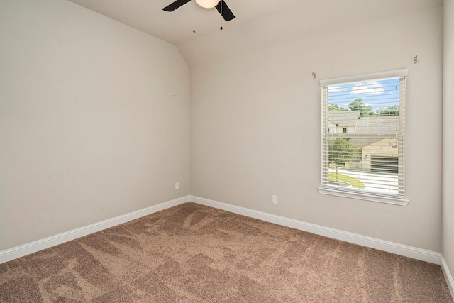 carpeted empty room with ceiling fan and vaulted ceiling