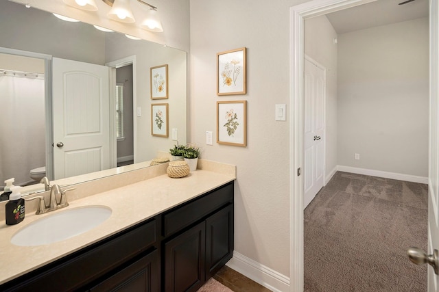 bathroom featuring vanity and toilet