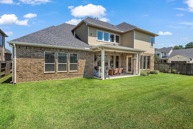 back of property featuring a yard and a patio