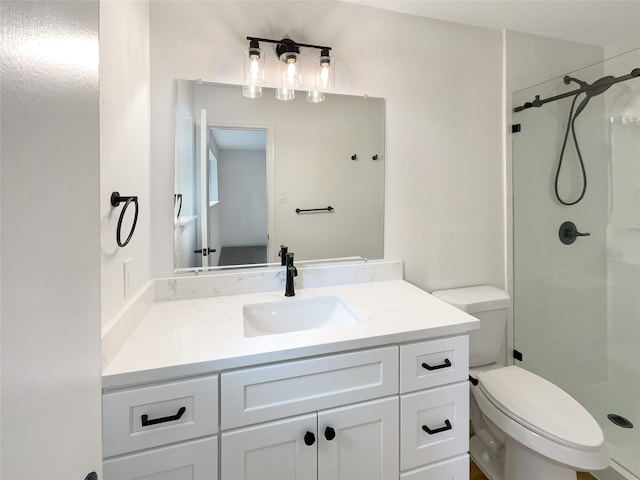 bathroom featuring walk in shower, vanity, and toilet