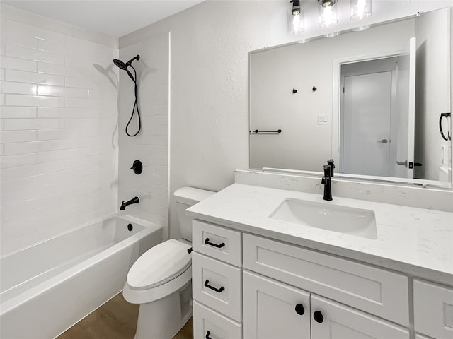 full bathroom featuring vanity, toilet, and tiled shower / bath