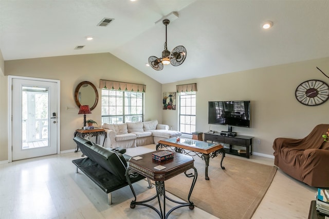 living room featuring light wood-type flooring and lofted ceiling