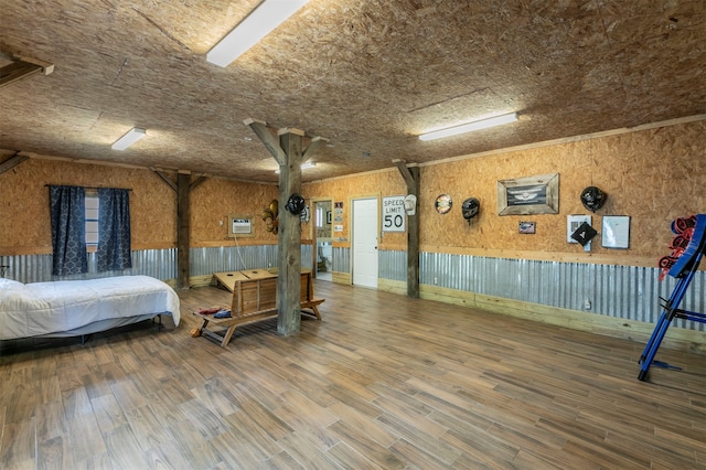 bedroom with hardwood / wood-style floors, ceiling fan, and ornamental molding