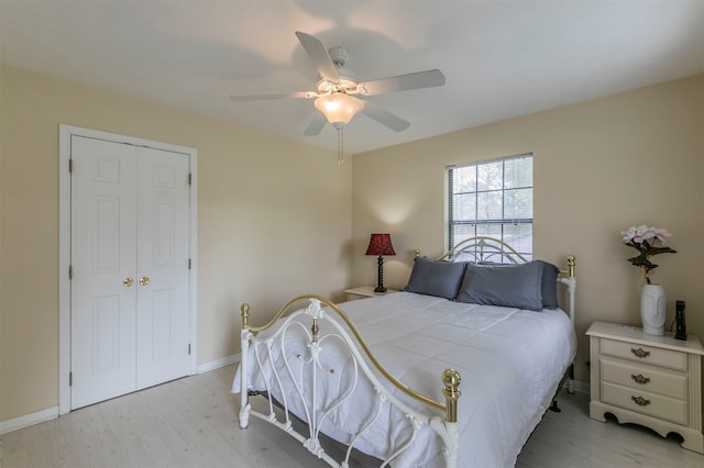 bedroom with ceiling fan, light wood-type flooring, and a closet