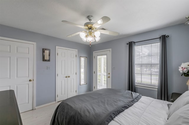 bedroom featuring ceiling fan, light hardwood / wood-style floors, and access to outside