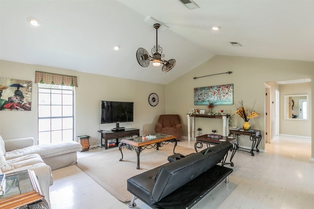 living room with light wood-type flooring and vaulted ceiling