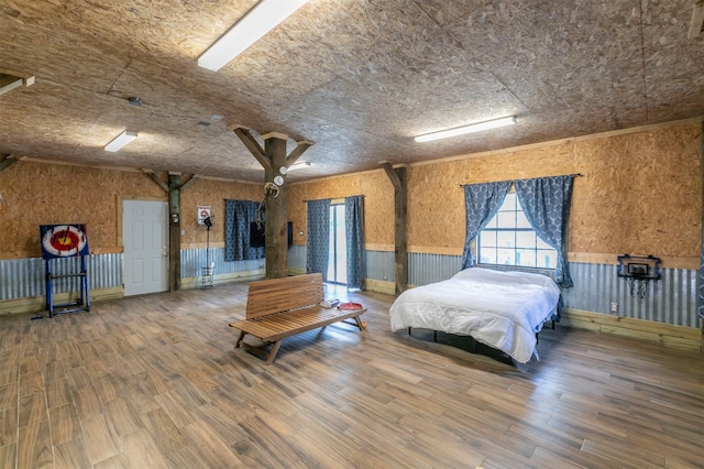 unfurnished bedroom featuring wooden walls and wood-type flooring