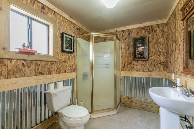 bathroom featuring tile patterned flooring, toilet, walk in shower, and sink