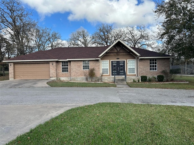 ranch-style home with a front lawn, a garage, and french doors