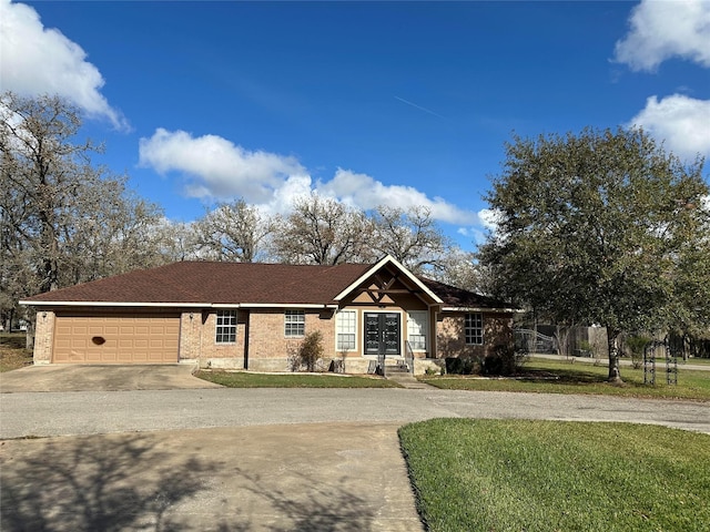 single story home featuring a garage, a front yard, and french doors