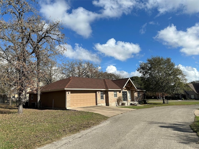 view of front of property with a garage and a front yard