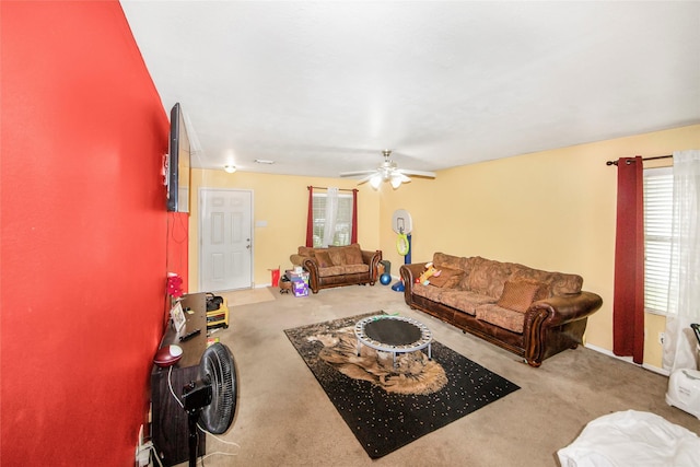 carpeted living room with ceiling fan