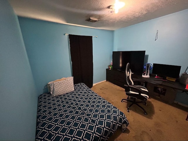 carpeted bedroom featuring a textured ceiling