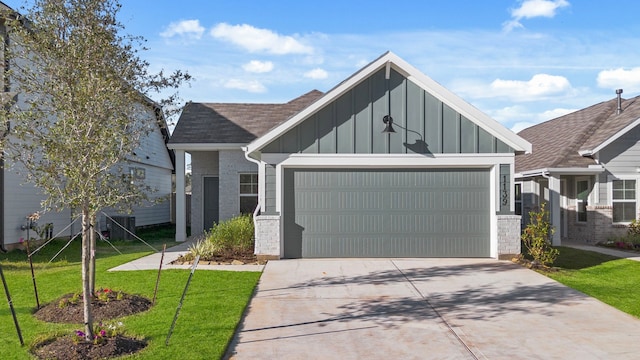 view of front of home with a garage and a front lawn