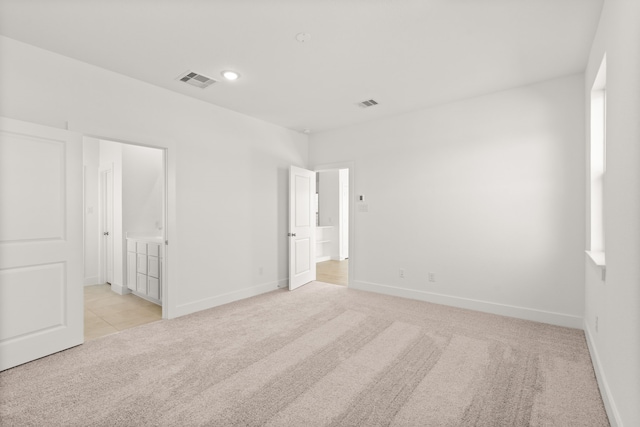 spare room with light colored carpet