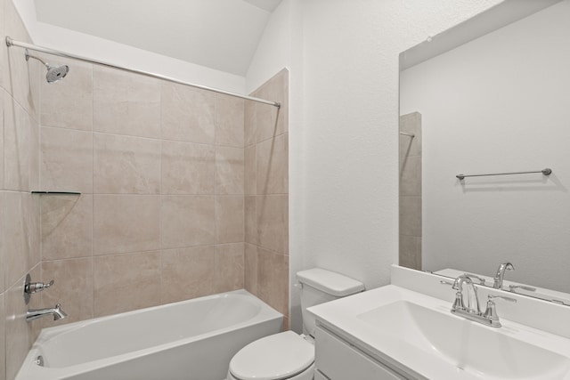 full bathroom with tiled shower / bath combo, toilet, lofted ceiling, and vanity