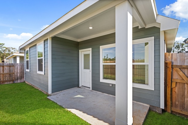 doorway to property featuring a lawn