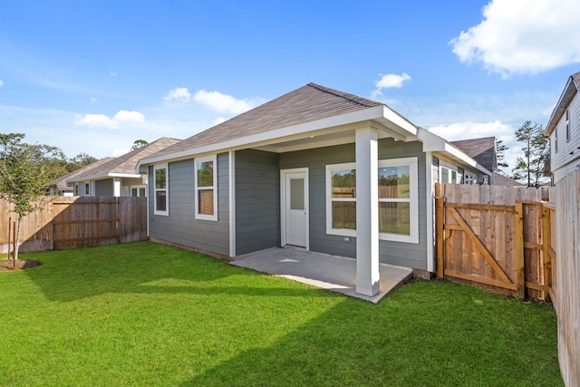 back of house featuring a patio area and a yard