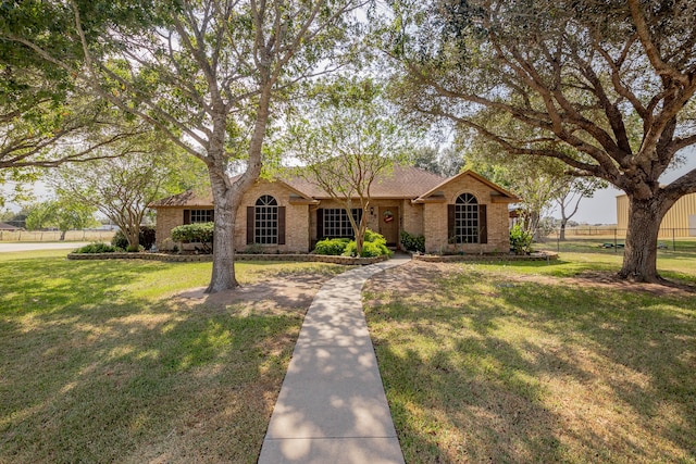 ranch-style home with a front lawn