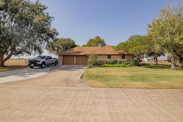 view of front of property featuring a front yard and a garage