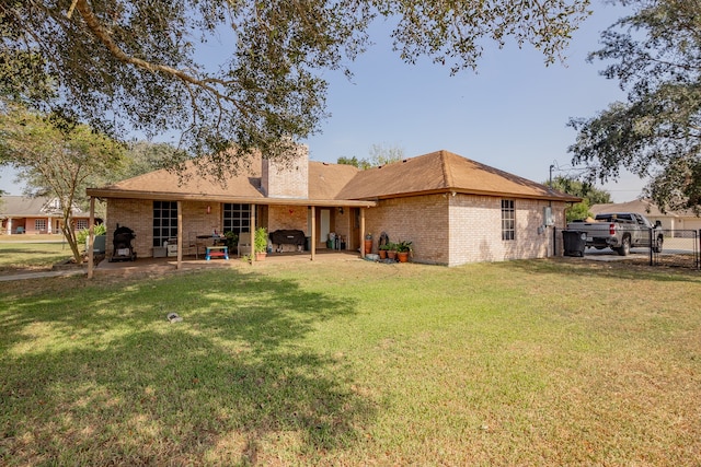 back of house featuring a patio area and a yard