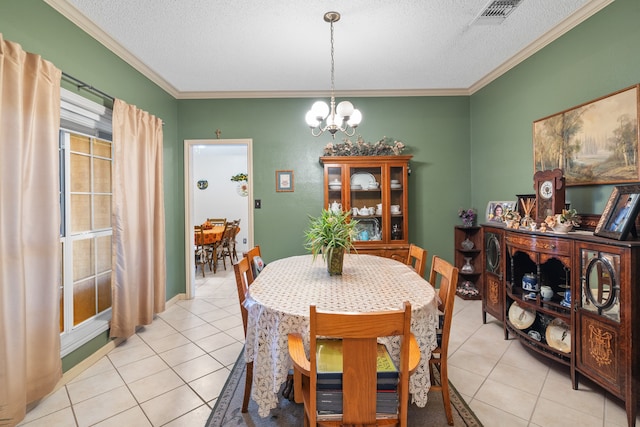 dining room with crown molding, light tile patterned floors, and a textured ceiling