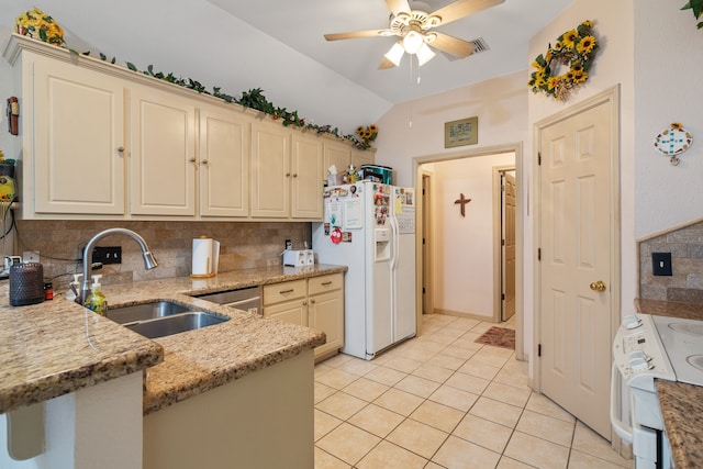 kitchen with tasteful backsplash, white appliances, vaulted ceiling, sink, and light tile patterned flooring