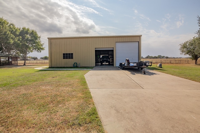 view of outdoor structure with a garage and a lawn