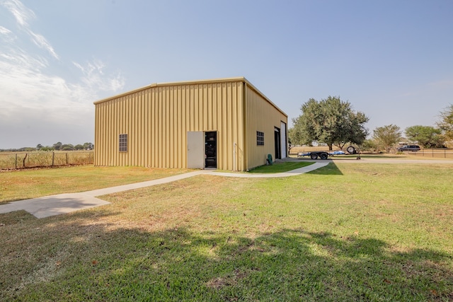 view of outbuilding featuring a lawn