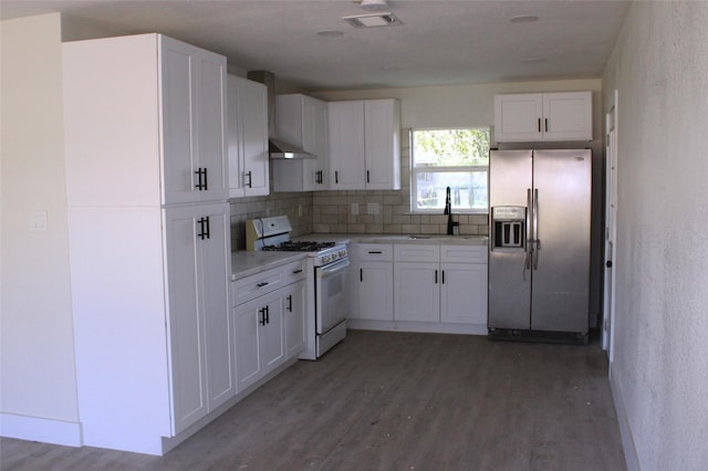 kitchen featuring gas range gas stove, white cabinets, and stainless steel refrigerator with ice dispenser