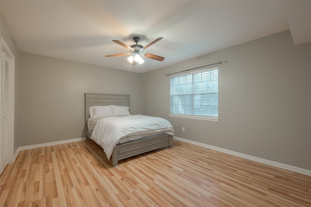 bedroom with a closet, ceiling fan, and light hardwood / wood-style flooring