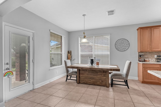 dining space featuring light tile patterned flooring