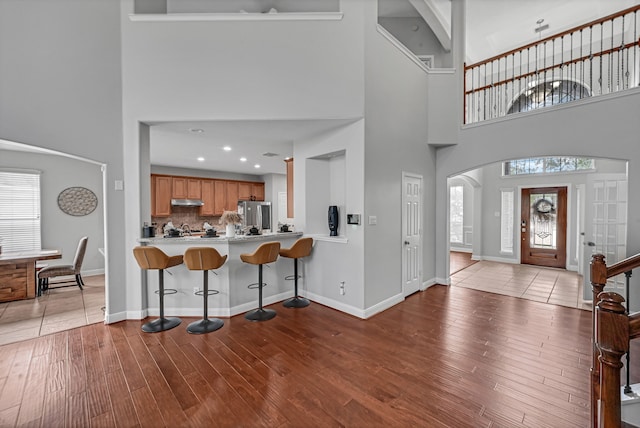 foyer entrance featuring a high ceiling and light hardwood / wood-style floors