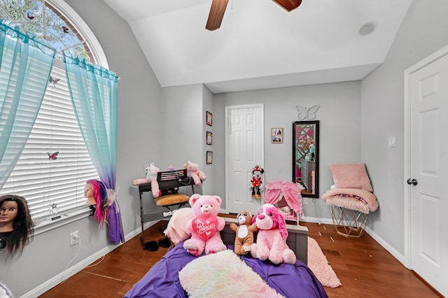 playroom featuring dark wood-type flooring and vaulted ceiling