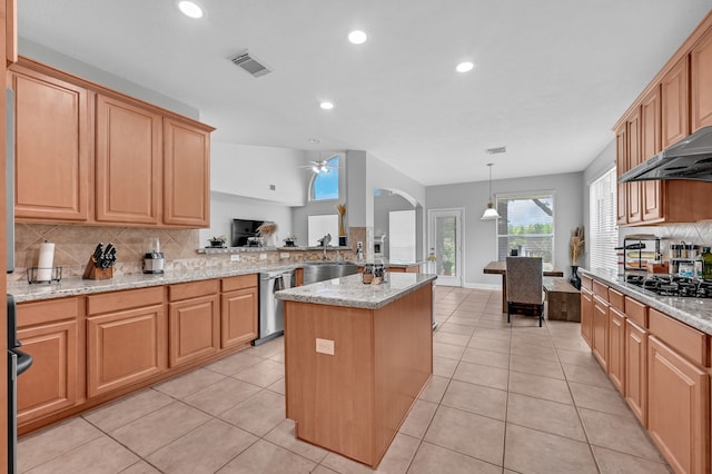 kitchen with gas cooktop, stainless steel dishwasher, a kitchen island with sink, ceiling fan, and decorative light fixtures