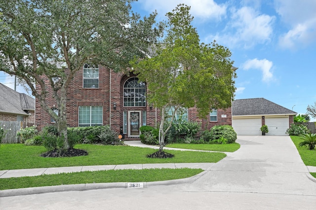 view of front of home with a garage and a front lawn