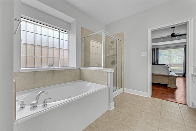 bathroom with tile patterned flooring, ceiling fan, and plus walk in shower