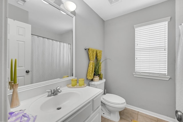 bathroom featuring tile patterned floors, vanity, and toilet