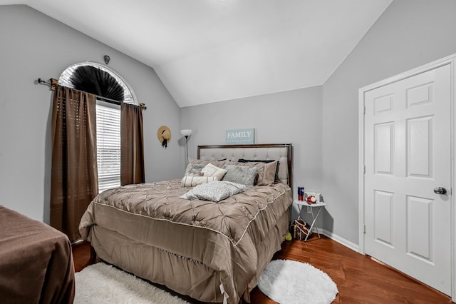 bedroom featuring wood-type flooring and lofted ceiling