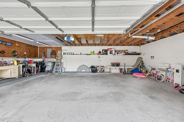 garage with electric panel and a garage door opener