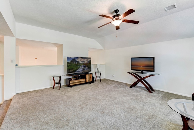 living area featuring carpet flooring, ceiling fan, a textured ceiling, and vaulted ceiling