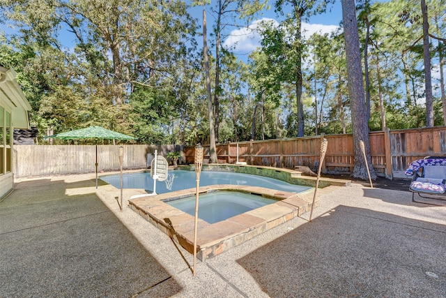 view of swimming pool with an in ground hot tub and a patio