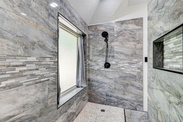 31202 Deerwood Park Ln, Spring City, TX 77386 - full bath featuring tiled shower, lofted ceiling, and a textured ceiling