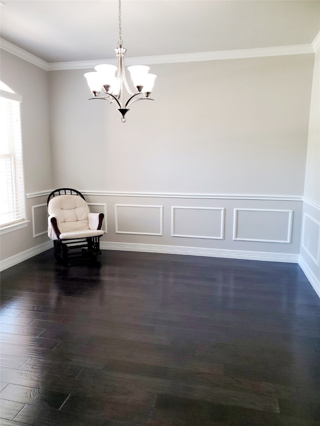 unfurnished room with dark hardwood / wood-style flooring, an inviting chandelier, and ornamental molding