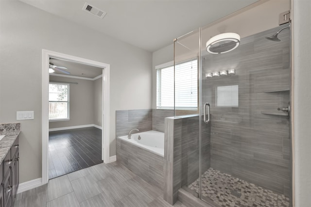 bathroom featuring vanity, ceiling fan, crown molding, hardwood / wood-style flooring, and shower with separate bathtub