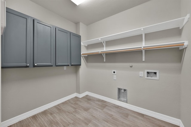 laundry room featuring cabinets, electric dryer hookup, gas dryer hookup, and hookup for a washing machine