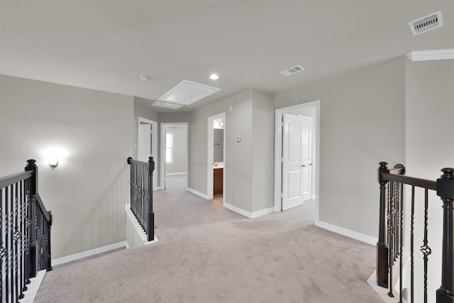 hallway featuring light colored carpet