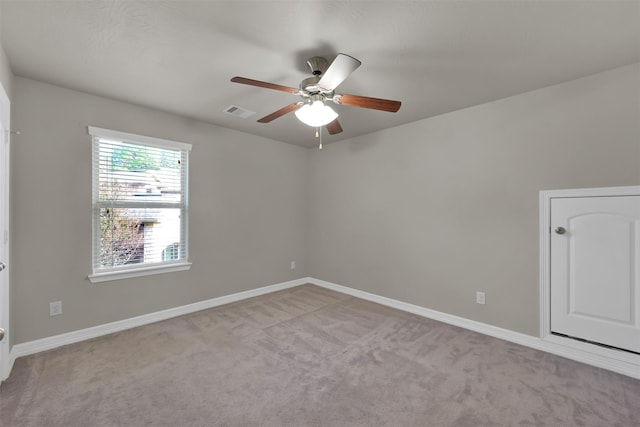 unfurnished room with ceiling fan and light carpet