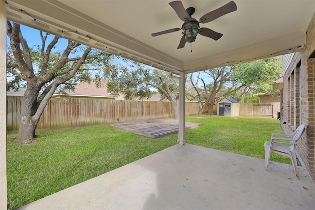 view of patio / terrace with ceiling fan and a shed