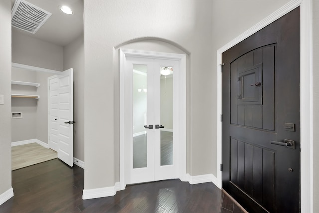 entrance foyer with dark hardwood / wood-style flooring and french doors